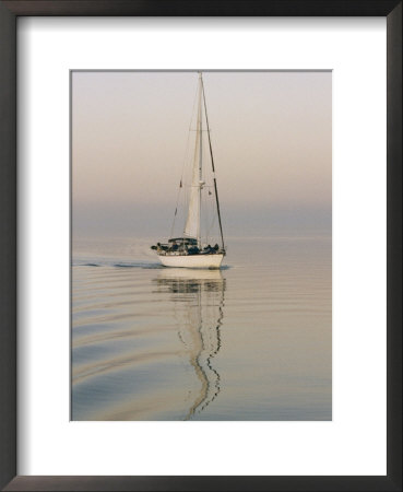Motoring Sailboat On Glassy Waters At Dusk by Rich Reid Pricing Limited Edition Print image