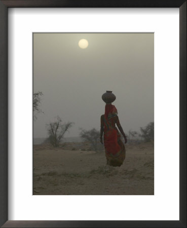 Woman Carrying Water Jar In Sand Storm, Thar Desert, Rajasthan, India by Keren Su Pricing Limited Edition Print image
