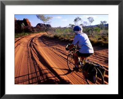 Cyclist On Outback Road, Purnululu National Park, Australia by Trevor Creighton Pricing Limited Edition Print image
