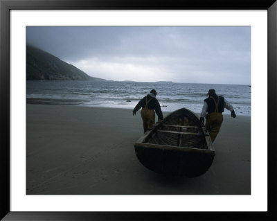 Commercial Salmon Fishermen Carry Their Boat Out To Check Their Nets by Paul Nicklen Pricing Limited Edition Print image