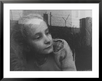 Girl Gazing Pensively Through Pane Of Her Apartment Window, Grimly Reflects Image Of Berlin Wall by Paul Schutzer Pricing Limited Edition Print image