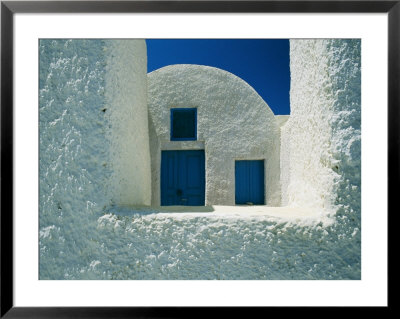 View Of The White Walls And Blue Doors Of One Of Theras Cliff-Top Houses by Todd Gipstein Pricing Limited Edition Print image