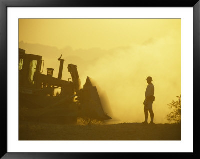 A Biologist Watches For Desert Tortoises As Bulldozers Roll Nearby by Joel Sartore Pricing Limited Edition Print image
