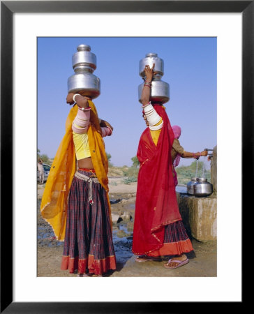Two Women By A Well Carrying Water Pots, Barmer, Rajasthan, India by Bruno Morandi Pricing Limited Edition Print image