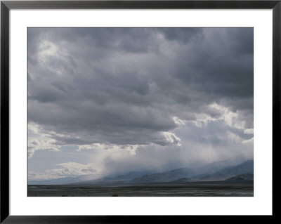 Rain Squalls Hover Over Panamint Range With Sun Over The Salt Pan by Gordon Wiltsie Pricing Limited Edition Print image