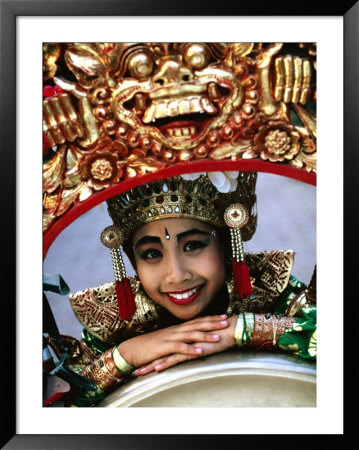 Portrait Of A Young, Legong Dancer Posing On Decorative Gong, Peliatan, Indonesia by Adams Gregory Pricing Limited Edition Print image