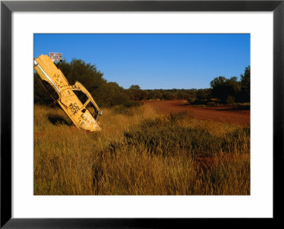 Car Buried In Ground, Great Central Road, Australia by Peter Ptschelinzew Pricing Limited Edition Print image