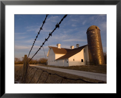 A Barbed Wire Fence Frames The Barn At Historical Steven's Creek Farm by Joel Sartore Pricing Limited Edition Print image