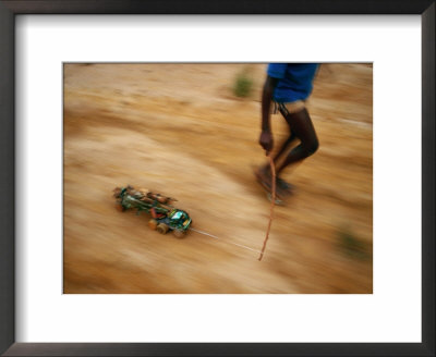 Child Pulling His Toy Truck At High Speed by Michael Nichols Pricing Limited Edition Print image
