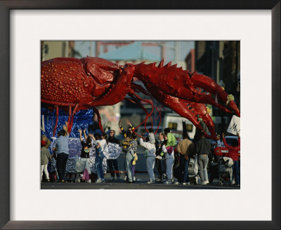 Louisianans Revel Beneath A Giant Crayfish Mardi Gras Float, New Orleans by Joel Sartore Pricing Limited Edition Print image