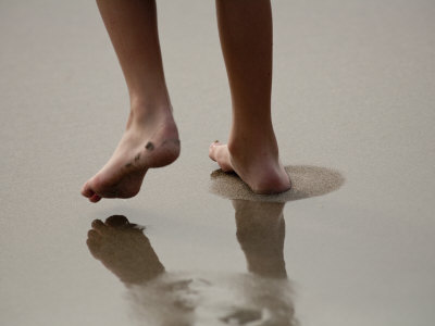 Teenage Boy Walking On Wet Sand Along The Shore by Stephen Alvarez Pricing Limited Edition Print image