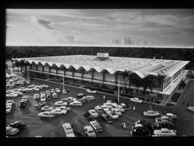 Overview Of Large Sears Roebuck Store With Rippled Roof, Surrounded By Parked Cars Of Shoppers by A.Y. Owen Pricing Limited Edition Print image