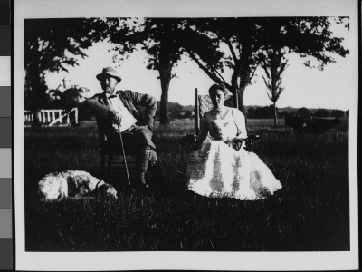 Dr. James Cornell And Wife Sitting In Chairs Out In A Field With Their Dog At Their Side by Wallace G. Levison Pricing Limited Edition Print image
