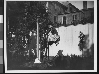 Zelma Levison Jumping In The Backyard Of Her Home At 314 Livingston St by Wallace G. Levison Pricing Limited Edition Print image