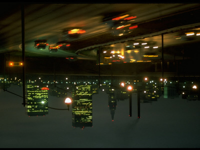 Traffic At Night On Highway With Skyscrapers In Distance by Ralph Crane Pricing Limited Edition Print image