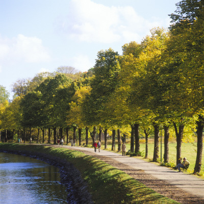 Group Of People Walking On The Road At A Riverside by Per-Erik Adamsson Pricing Limited Edition Print image