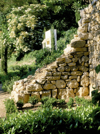 La Chabaude, France: Designer Scott Stover: Modern Water Feature On Hillside With Stone Wall by Clive Nichols Pricing Limited Edition Print image