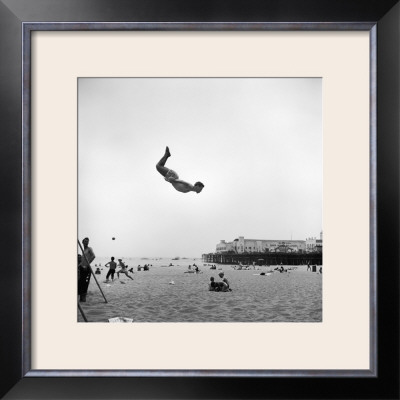 Man Flying Off A Trampoline At Santa Monica Beach by Loomis Dean Pricing Limited Edition Print image