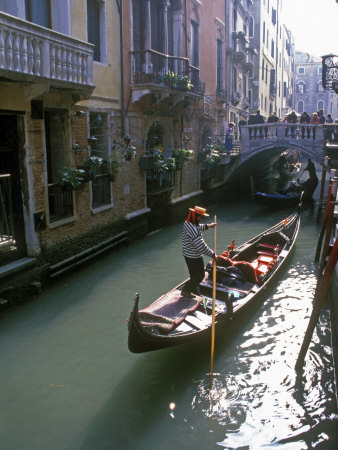 Boatman Poles A Gondola In A Venice Canal, People On A Bridge Watch by Stephen Sharnoff Pricing Limited Edition Print image
