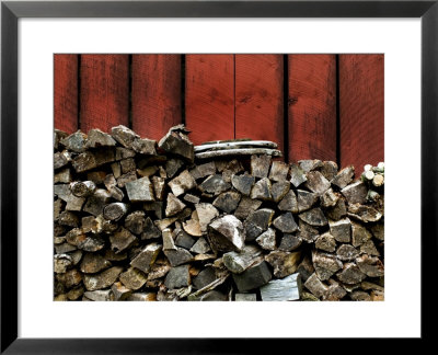 Large Stack Of Fire Wood Piled Next To A Red Barn Wall by Todd Gipstein Pricing Limited Edition Print image
