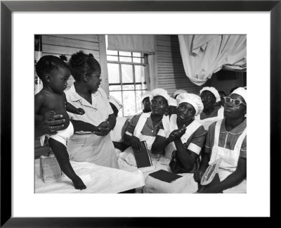 Nurse/Midwife Maude Callen Holds Baby And Teaches Class In Midwifery How To Look For Abnormalities by W. Eugene Smith Pricing Limited Edition Print image