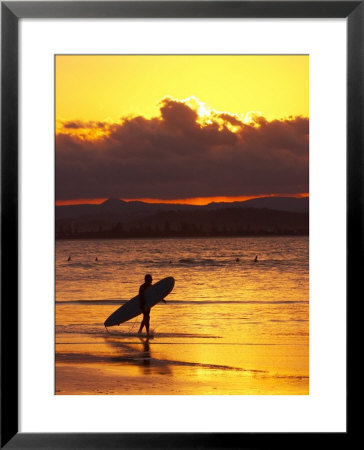 Person With Surfboard Walking Along Beach At Sunset, Gold Coast, Queensland, Australia by David Wall Pricing Limited Edition Print image
