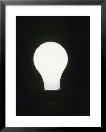 Light Bulb Glows In A Dark Room by Taylor S. Kennedy Pricing Limited Edition Print image