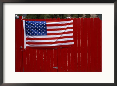 A United States Flag Hangs On A Bright Red Fence by Raul Touzon Pricing Limited Edition Print image