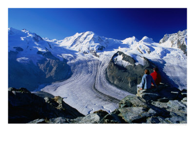 Hikers On A Rock At Gornergrat Look Towards Liskamm And The Gorner Glacier, Zermatt, Switzerland by David Tomlinson Pricing Limited Edition Print image