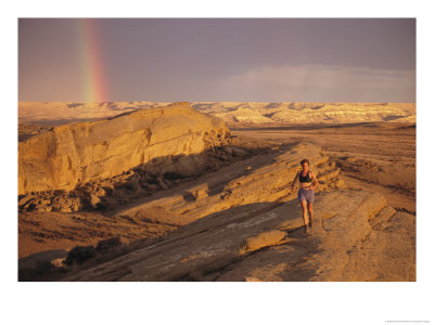 Woman Trail Running In A Rocky Landscape With A Rainbow by Bobby Model Pricing Limited Edition Print image