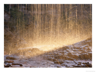 Backlit Drops Of Water Pelting Rocks by John Dunn Pricing Limited Edition Print image