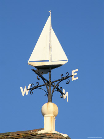 Wind Wheel (Weather Vane) On Top Of A Pub Roof, Harbour, Lymington, Hampshire, England by Brigitte Bott Pricing Limited Edition Print image