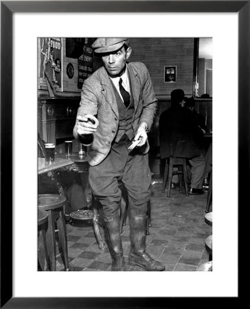 Man Playing Quoits, Like Horse Shoes, In An English Pub by Hans Wild Pricing Limited Edition Print image