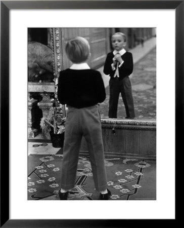 English Boy Using Reflection In Mirror In Foyer Of Grand Hotel To Fix His Tie by Alfred Eisenstaedt Pricing Limited Edition Print image
