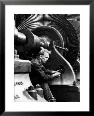 Laborer Tightening Bolt Next To Large Piece Of Machinery by Margaret Bourke-White Pricing Limited Edition Print image