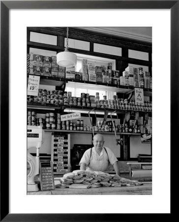 Butcher Standing At Meat Counter Of Deli by Alfred Eisenstaedt Pricing Limited Edition Print image