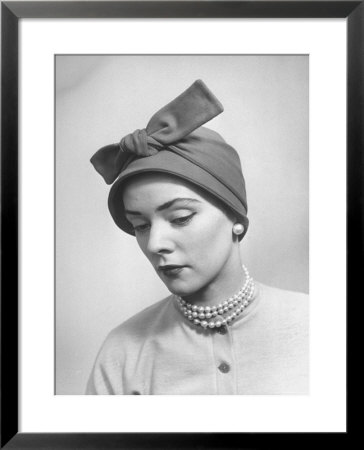 Model Posing In A Bonnet Styled Hat With Streamers That Are Drawn Around The Back Of The Head by Nina Leen Pricing Limited Edition Print image