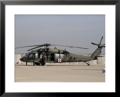 Uh-60 Blackhawk Medivac Helicopter Refuels At Camp Warhorse After A Mission by Stocktrek Images Pricing Limited Edition Print image