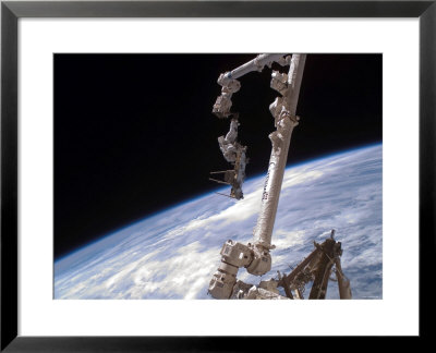 Nchored To The International Space Station's Canadarm2 Foot Restraint by Stocktrek Images Pricing Limited Edition Print image
