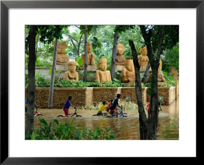 Children Riding Bikes Through Floodwaters by Peter Ptschelinzew Pricing Limited Edition Print image