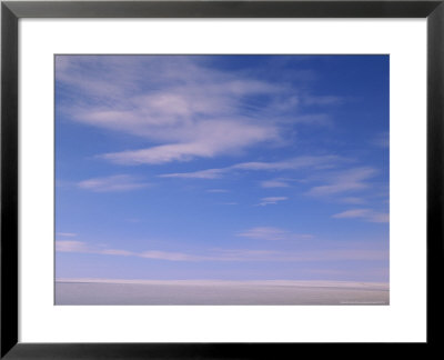 Wispy Clouds Over An Ice-Covered Lake In Alaska by John Eastcott & Yva Momatiuk Pricing Limited Edition Print image