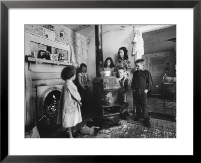 Poverty Stricken Family Huddling Around A Wood Stove In Their Home by John Dominis Pricing Limited Edition Print image