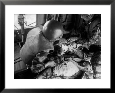 Cpl. James Farley And Pfc. Wayne Hoilien Bandaging Sgt. Billie Owens' Shoulder, Yankee Papa 13 by Larry Burrows Pricing Limited Edition Print image