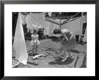 Suburban Mother Playing With Her Two Daughters While Hanging Laundry In Backyard by Alfred Eisenstaedt Pricing Limited Edition Print image