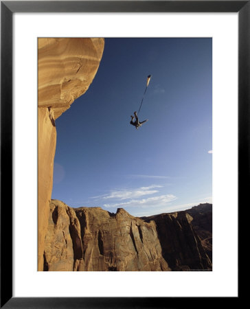 Base Jumper Leaping With A Parachute From The Tombstone Formation by Jimmy Chin Pricing Limited Edition Print image