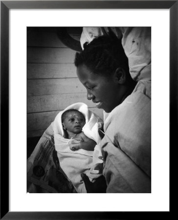 Nurse-Midwife Maude Callen Shows Smiling Alice Her Newborn Son by W. Eugene Smith Pricing Limited Edition Print image