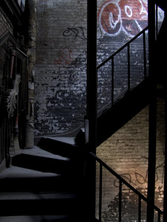 A Dark And Mysterious Looking Stairway With Graffiti And Fire Hose by Oote Boe Pricing Limited Edition Print image
