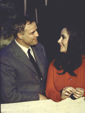 Actress Elizabeth Taylor With Actor Marlon Brando Filming Movie Reflections In A Golden Eye by Loomis Dean Pricing Limited Edition Print image