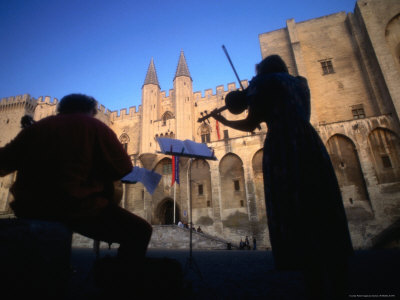 Musicians Playing In Front Of Palais Des Papes (Palace Of The Popes), Vaucluse, Avignon, France by Jon Davison Pricing Limited Edition Print image