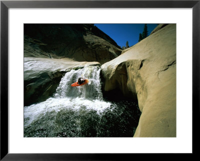 Suspended In Mid-Air, A Kayaker Sails Down A Short Waterfall And Is Headed For White Water Below by Barry Tessman Pricing Limited Edition Print image